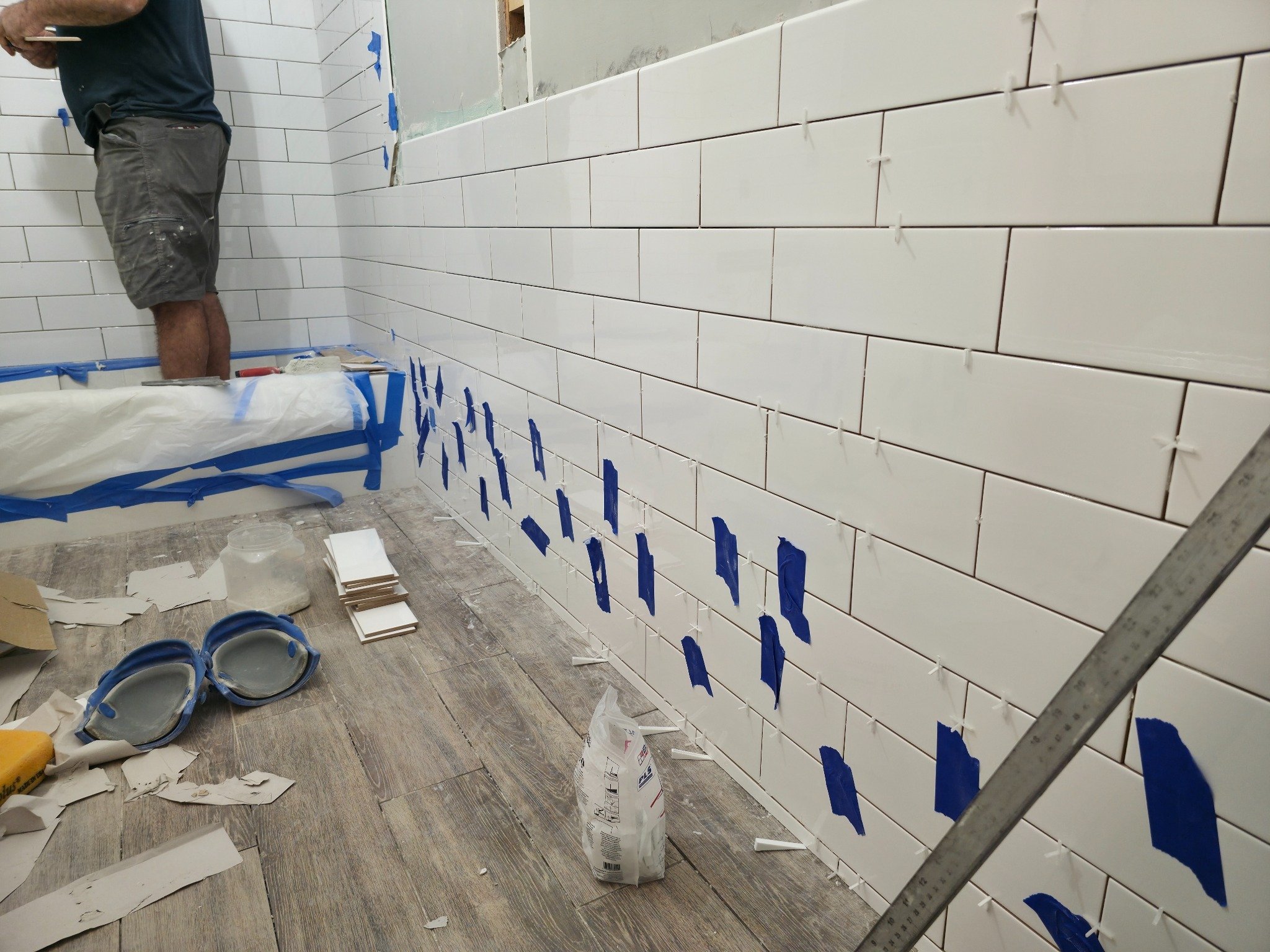 Subway tile being set on tub surround walls during bathroom remodel — Carrboro NC