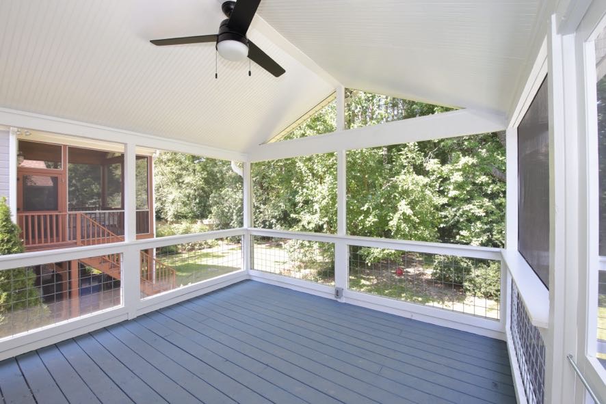 Screened porch interior corner view with wire railing and vaulted beadboard ceiling in Durham NC