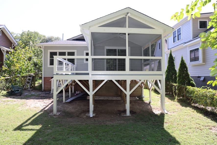 Rear exterior of completed screened porch addition showing gable roofline and elevated structure in Durham NC
