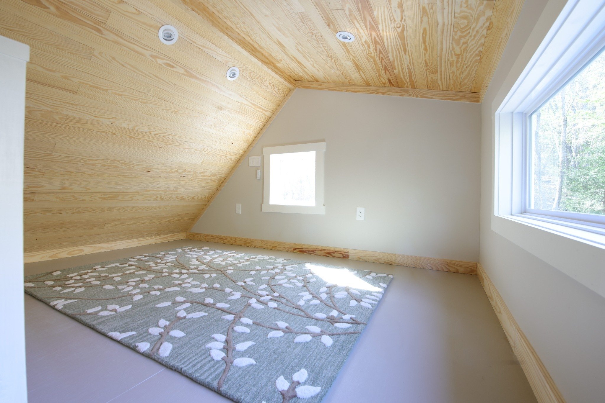 Finished loft room in backyard office shed with wood ceiling and dormer window in Durham NC