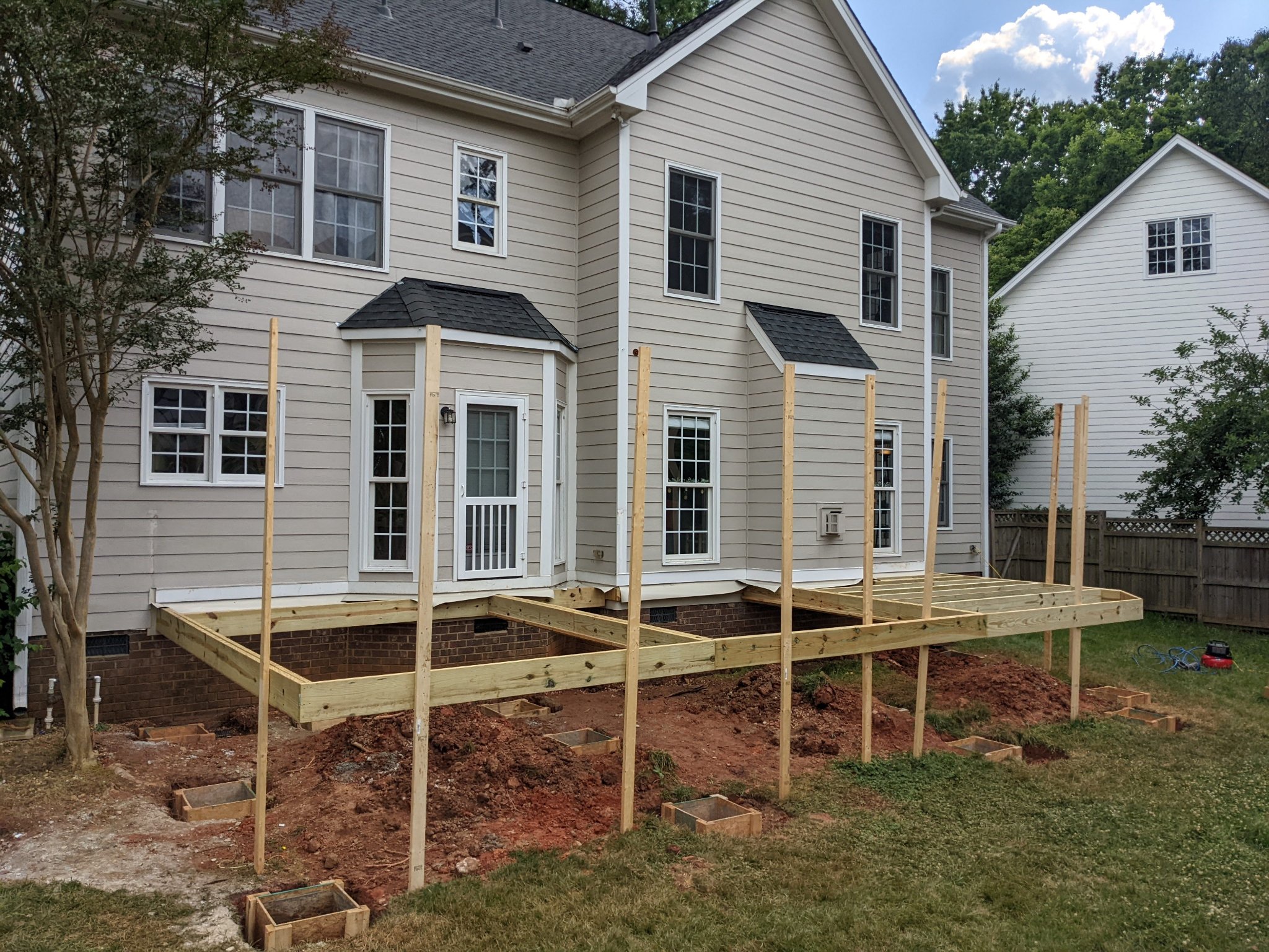 Deck framing and pergola post layout with concrete footings poured in Raleigh NC