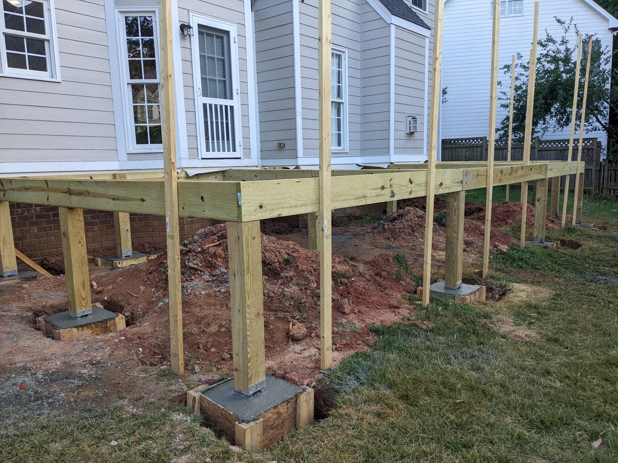 Concrete footings and pressure-treated post bases for elevated deck in Raleigh NC
