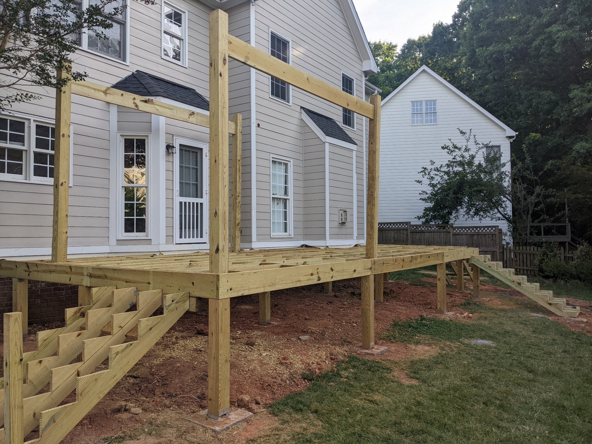 Deck subframe with pergola posts and stair framing in Raleigh NC