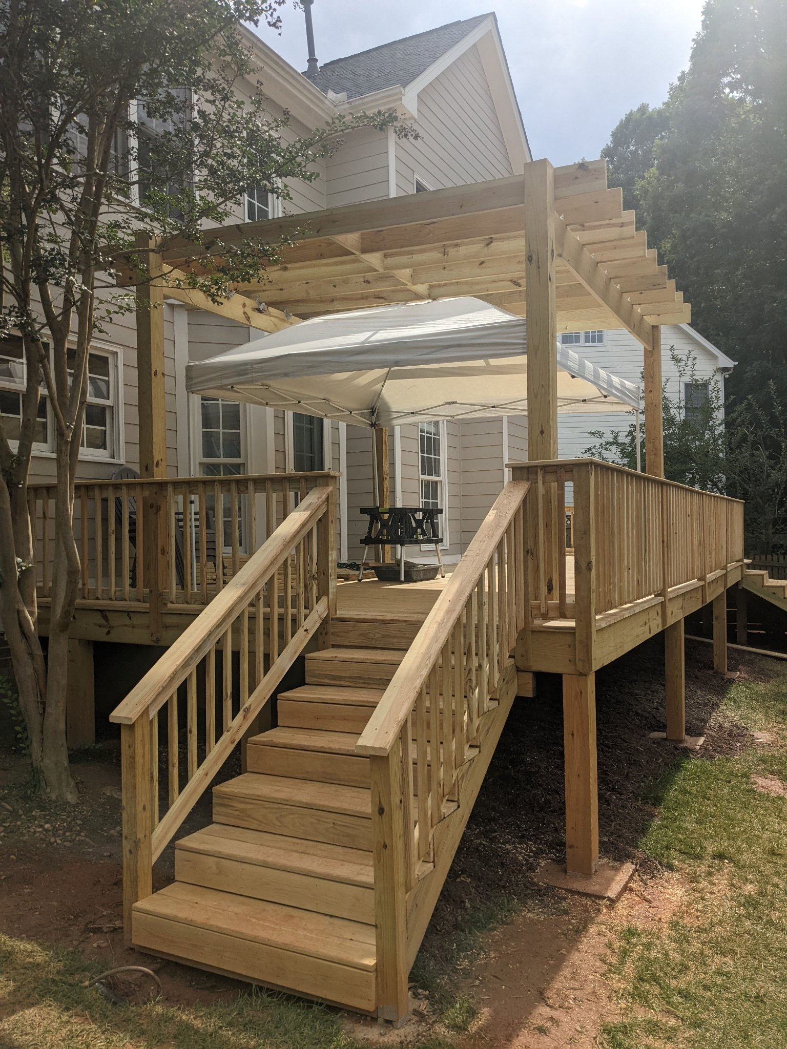 Completed elevated deck with pergola and center stair access in Raleigh NC