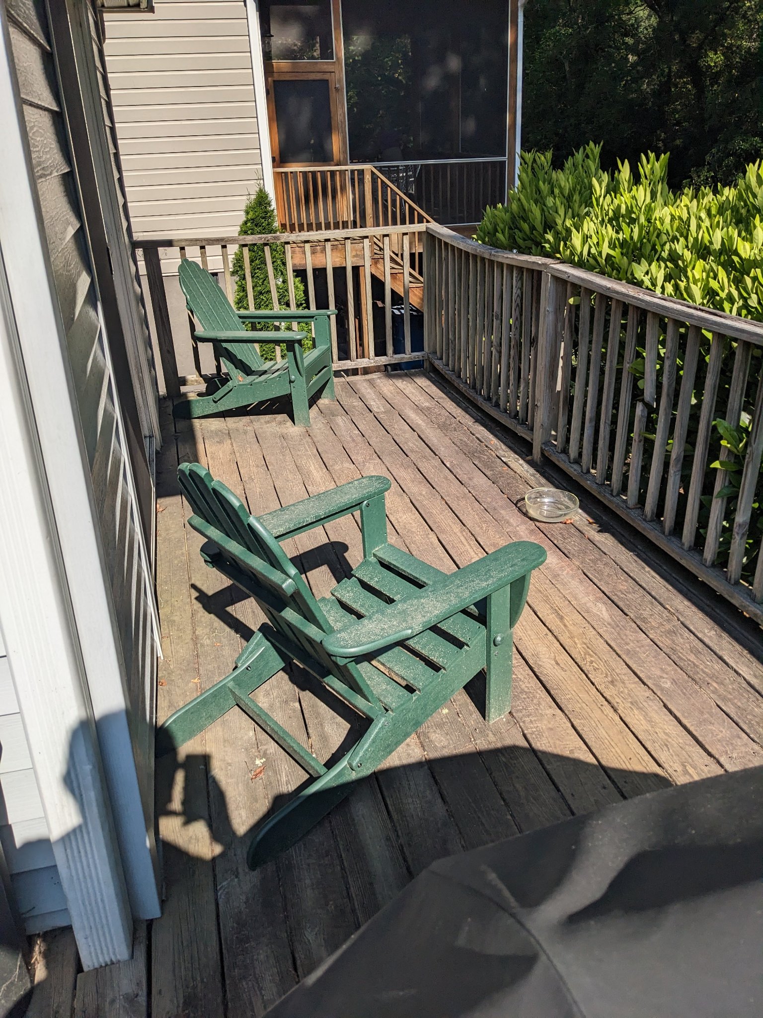 Original rear deck with Adirondack chairs and weathered boards before remodeling in Durham NC