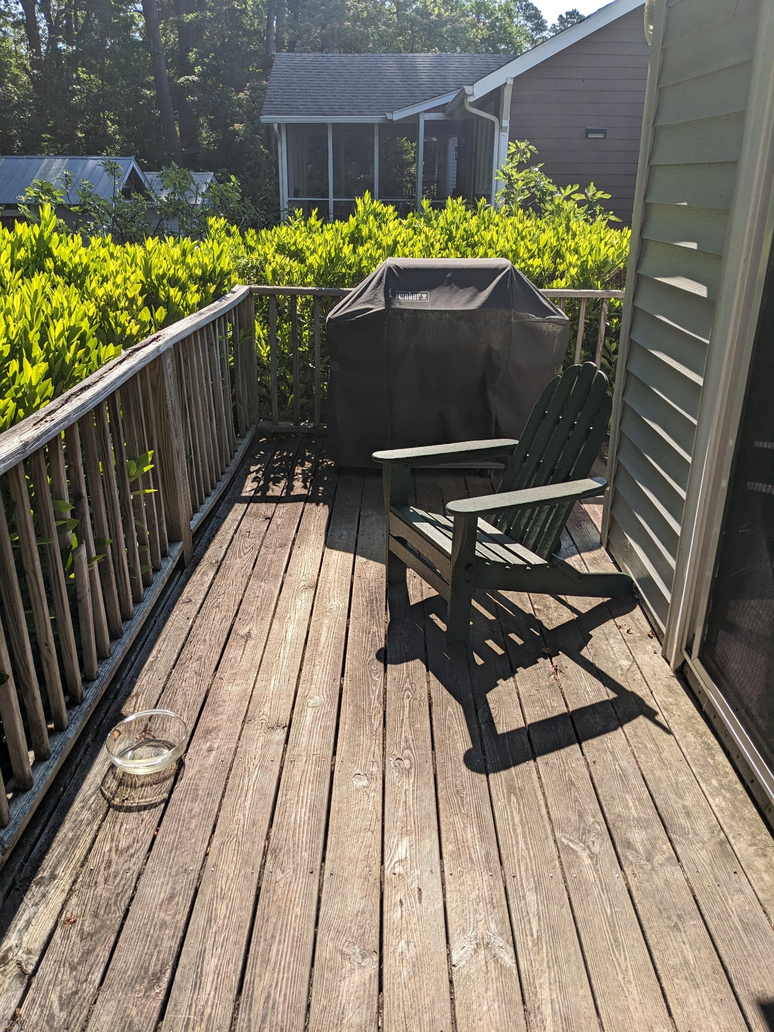 Original deck corner with grill and weathered boards before screened porch project in Durham NC