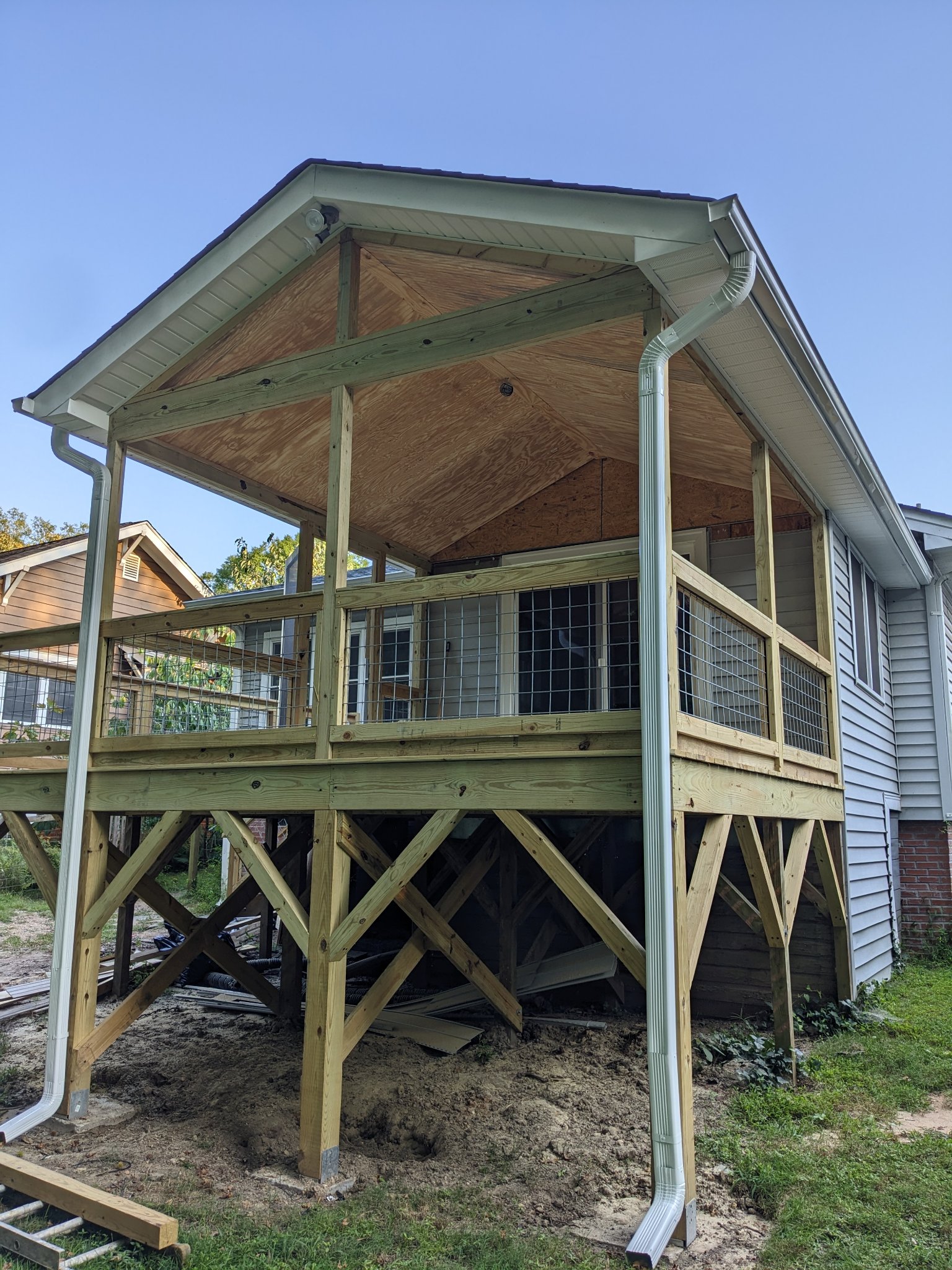 Screened porch structural framing with wire railing panels and plywood sheathing in Durham NC