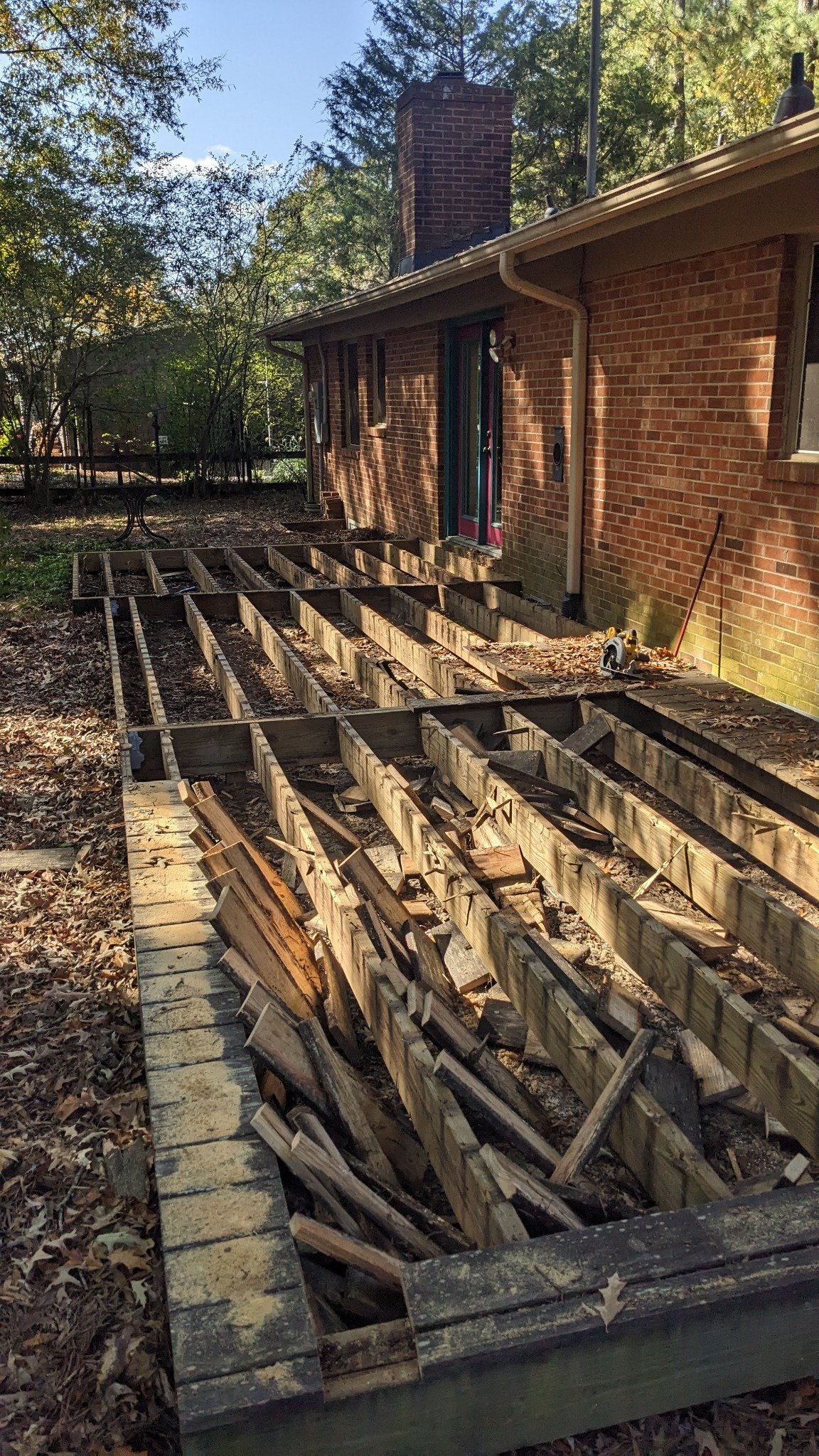 Deck boards stripped and rotted framing exposed during demo of old deck in Carrboro NC