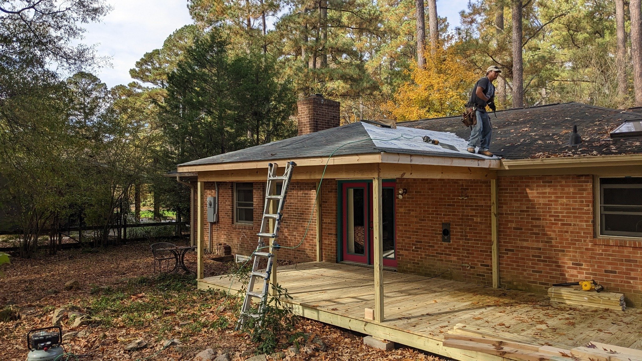 Screened porch walls and railing framed in natural pressure-treated wood during construction in Carrboro NC